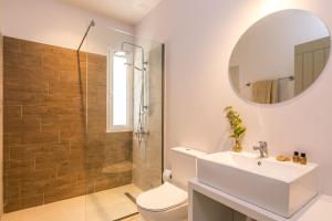 a bathroom with a toilet and a sink and a shower at Luna Inn B&B in Corfu +61 photos