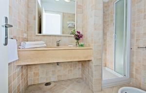 a bathroom with a tub, sink and mirror at Hotel La Tosca in Capri