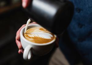a person is holding a cup of coffee at Ben Cruachan Inn - Restaurant, Pub with Rooms in Loch Awe