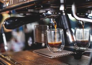 a coffee being poured into two glasses on a bar at Ben Cruachan Inn - Restaurant, Pub with Rooms in Loch Awe