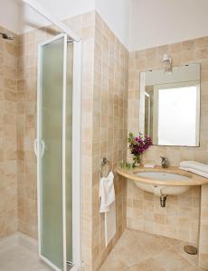 a bathroom with a sink and a mirror at Hotel La Tosca in Capri