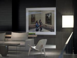 two people taking a picture of a painting in a museum at The Met Hotel Thessaloniki, a Member of Design Hotels in Thessaloniki