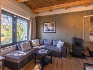 a living room with a couch and a stove at Ferienhaus Große Sommerliebe in Waren