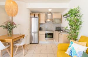 a kitchen and dining room with a table and a refrigerator at Beach Apartment in the heart of Tamariu in Tamariu