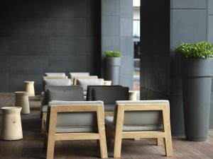 a row of tables and chairs in a room at The Met Hotel Thessaloniki, a Member of Design Hotels in Thessaloniki