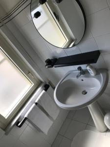 a bathroom with a sink and a mirror at Appartamenti Le Mimose in Santa Maria Navarrese