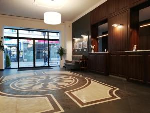 a lobby with a spiral design on the floor at Bristol Residence in Bytom