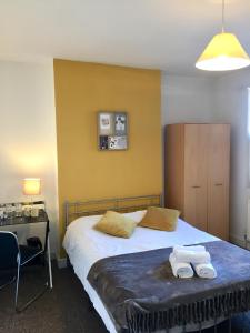 a bedroom with a bed with two towels on it at Summerfield House in Birmingham