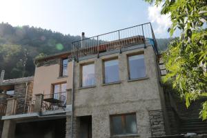 ein Gebäude mit Balkon darüber in der Unterkunft Casa Flora in Verdabbio