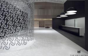 a lobby with a wall with a patterned wall at The Met Hotel Thessaloniki, a Member of Design Hotels in Thessaloniki