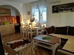 a living room with a couch and a table at Apartman Nikocevic in Dobra Voda