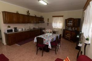 a kitchen with a table and chairs in a room at Casa do Galante in Porto Judeu