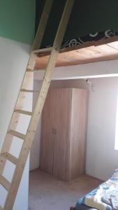 a ladder to a bunk bed in a room at Rooms in the apartment-center in Košice