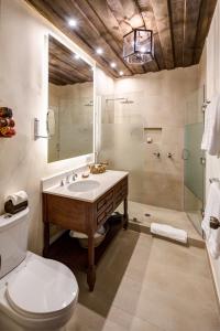 a bathroom with a sink and a shower and a toilet at Porta Hotel Antigua in Antigua Guatemala