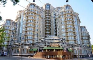 a large apartment building with a sign on it at Panoramic 1-BR apartment in the heart of Odessa in Odesa