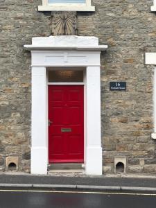
a red brick building with a red door at Pinfold House in Richmond
