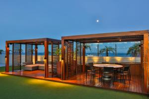 a rendering of a house with a table on a deck at Quality Suítes João Pessoa in João Pessoa
