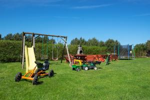 a group of toys in the grass with a playground at Willa Octavia in Jastrzębia Góra