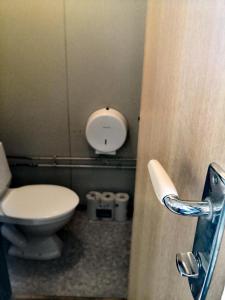 a bathroom with a toilet and a toilet paper dispenser at Winjum Cabin Aurland Stegastein in Aurland