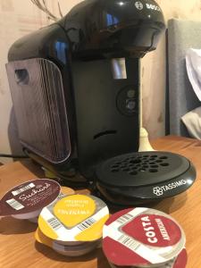 a coffee maker sitting on top of a wooden table at Rokeby Inn in Newsham