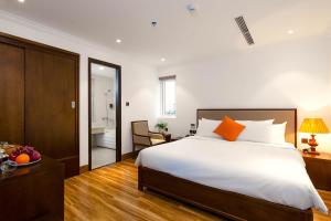 Postel nebo postele na pokoji v ubytování Roliva Hotel & Apartment Danang