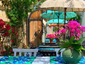 a table with a vase of flowers on a patio at Rue d'Azur Alaçatı in Alacati