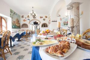 a room with a table with croissants and other foods at Hotel Casa Giuseppina in Ischia