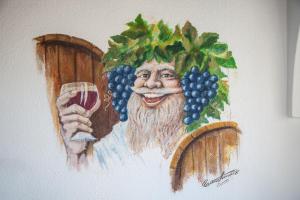 a painting of a man with a bunch of grapes at Hotel Casa Giuseppina in Ischia