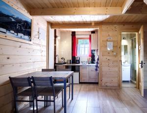 a kitchen and dining room with a table and chairs at Oaza Tatry III in Zakopane