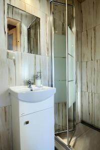 a bathroom with a sink and a mirror at Oaza Tatry III in Zakopane