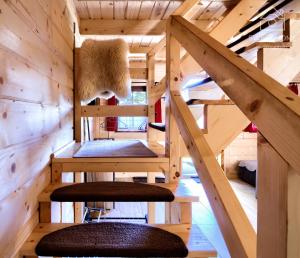 a tree house with a loft bed and stairs at Oaza Tatry III in Zakopane