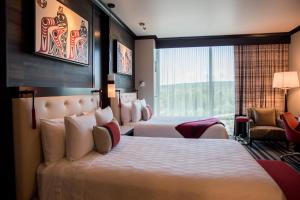a hotel room with two beds and a window at Tulalip Resort Casino in Marysville