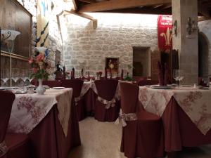 a set of tables in a room with red and white table cloth at Señorio de Olmillos in Olmillos de Sasamón