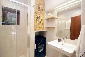 a bathroom with a sink and a washing machine at Apartments Ardura in Petrovac na Moru +58 photos