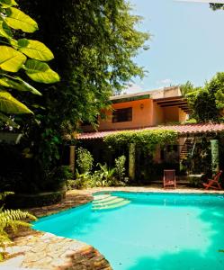 a swimming pool in front of a house at Casa Quetzal Hotel in Valladolid