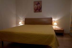 a bedroom with a bed and two lamps on tables at Flowers Denia in Denia