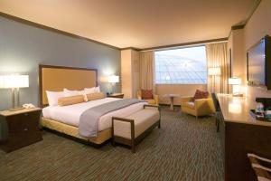 a hotel room with a bed and a large window at Harrah's Resort Atlantic City Hotel & Casino in Atlantic City