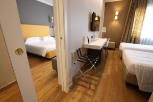 a hotel room with a sink and two beds at Hotel Umbria in Attigliano