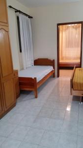 a bedroom with a bed and a window in it at Guesthouse Ada in Bar