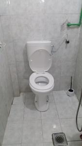 a bathroom with a white toilet in a stall at Guesthouse Ada in Bar