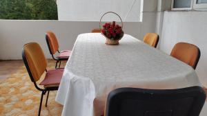 a table with a white table cloth and a basket of fruit at Guesthouse Ada in Bar