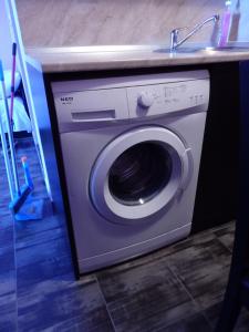 a washing machine under a counter with a sink at Studio-Pomorie in Pomorie