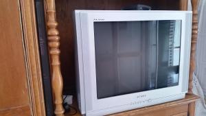 a television sitting on top of a wooden stand at Guesthouse Ada in Bar