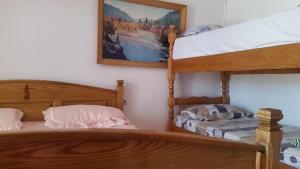 a bedroom with two bunk beds and a bed at Guesthouse Ada in Bar
