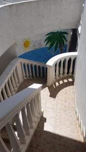 a room with a staircase with a table and a plant at Guesthouse Ada in Bar