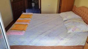 a large bed with two pillows on top of it at Guesthouse Ada in Bar