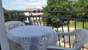 a white table and chairs on a balcony at Guesthouse Ada in Bar