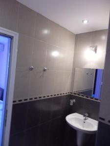 a bathroom with a sink and a toilet and a mirror at Studio-Pomorie in Pomorie +20 photos