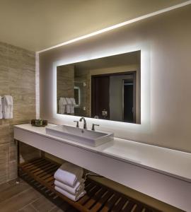 a bathroom with a sink, mirror and bath tub at Bally's Lake Tahoe Casino Resort in Stateline