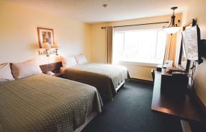 a hotel room with two beds and a window at Kings Landing in Homer